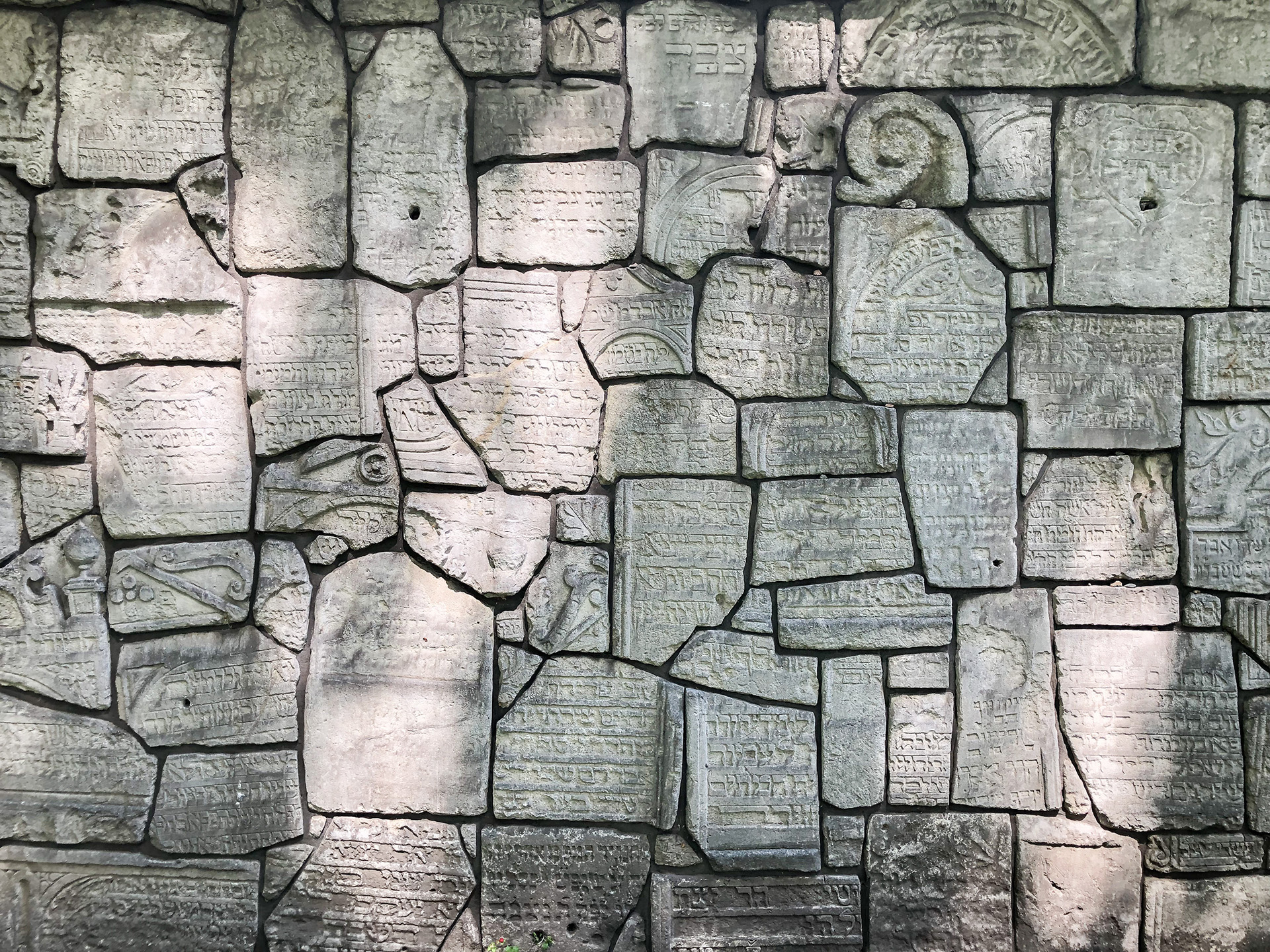 Brick wall with symbols imprinted in the bricks